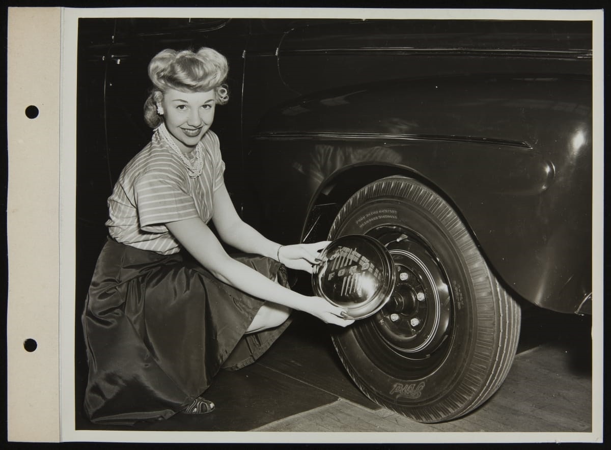 Leota Carroll with 1945 Ford Sedan hubcap